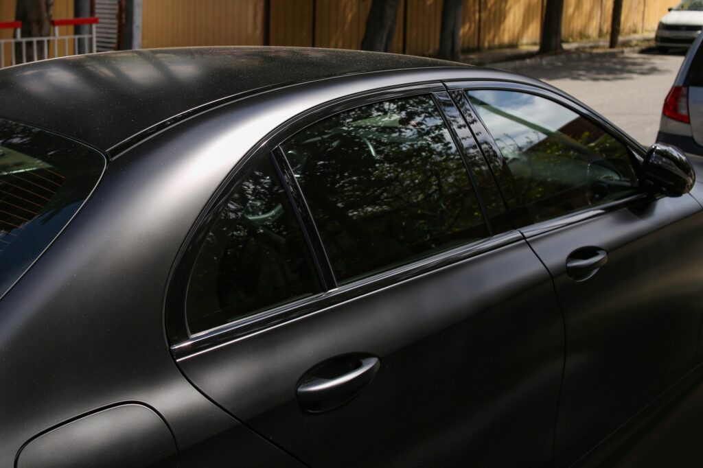 Black sedan with dark tinted windows