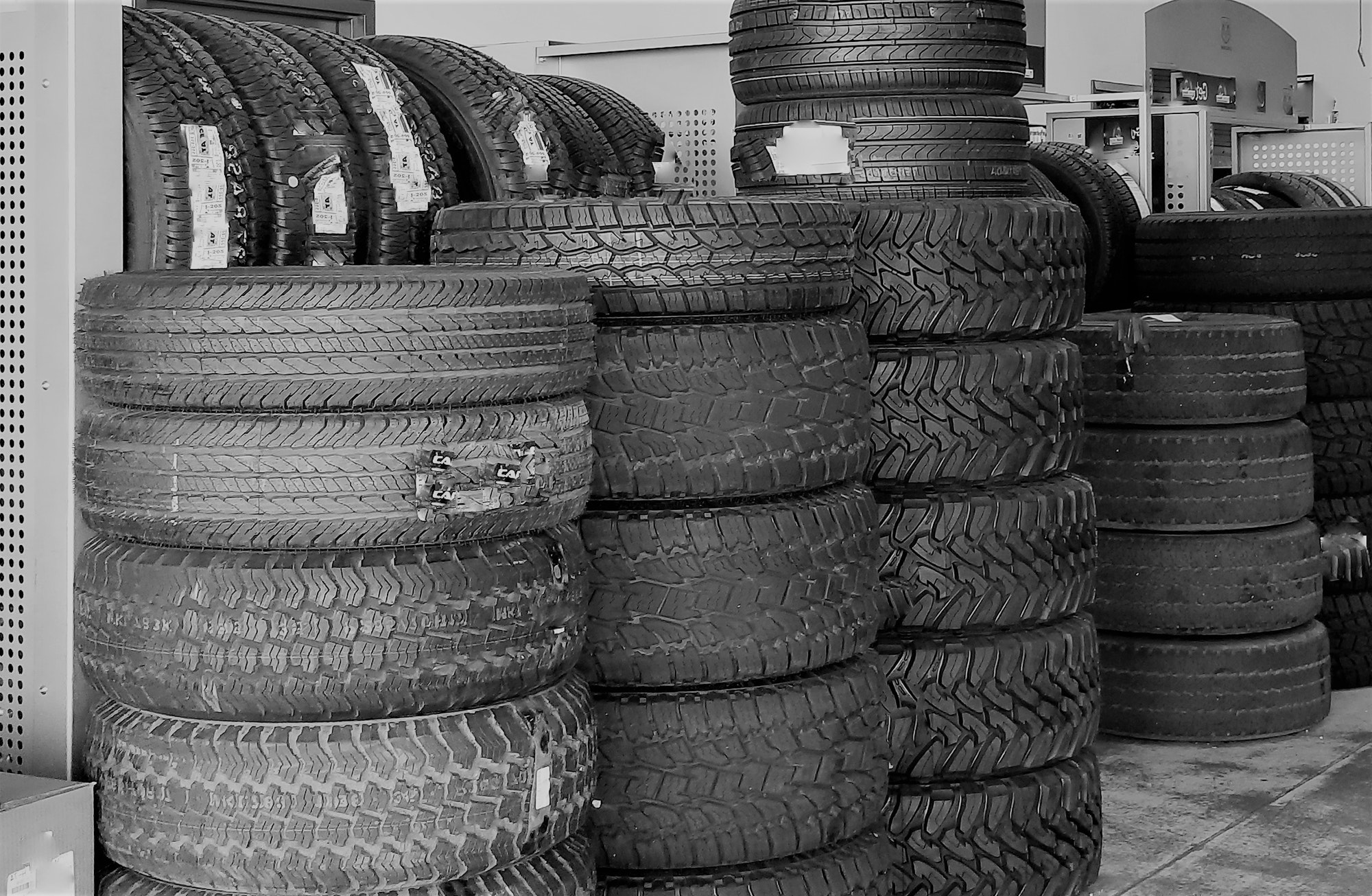 Stacks of new and used tires inside the tire shop
