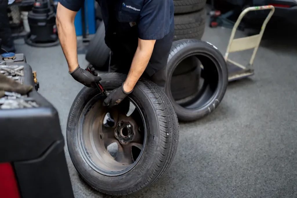 Mechanic mounting a tire on a tire machine