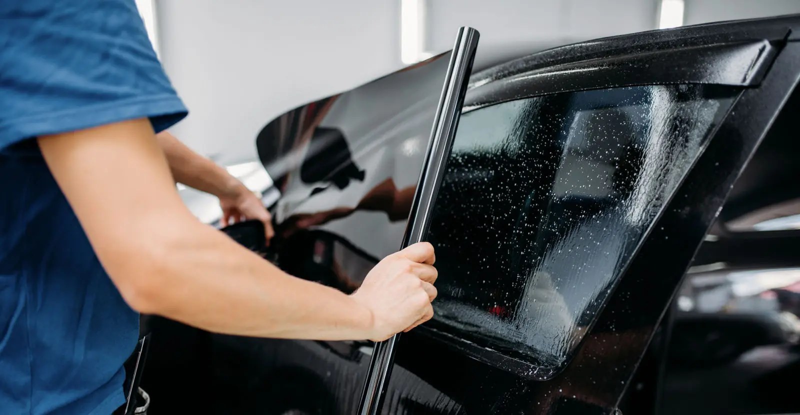 Tint film being positioned on a car's rear side window
