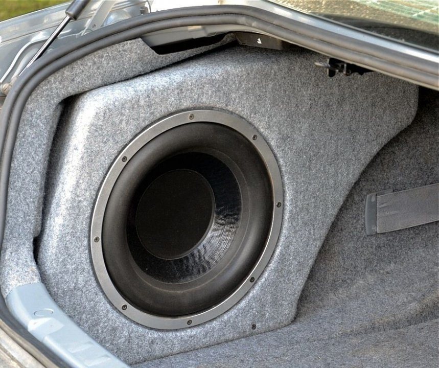 Custom subwoofer enclosure built into a trunk